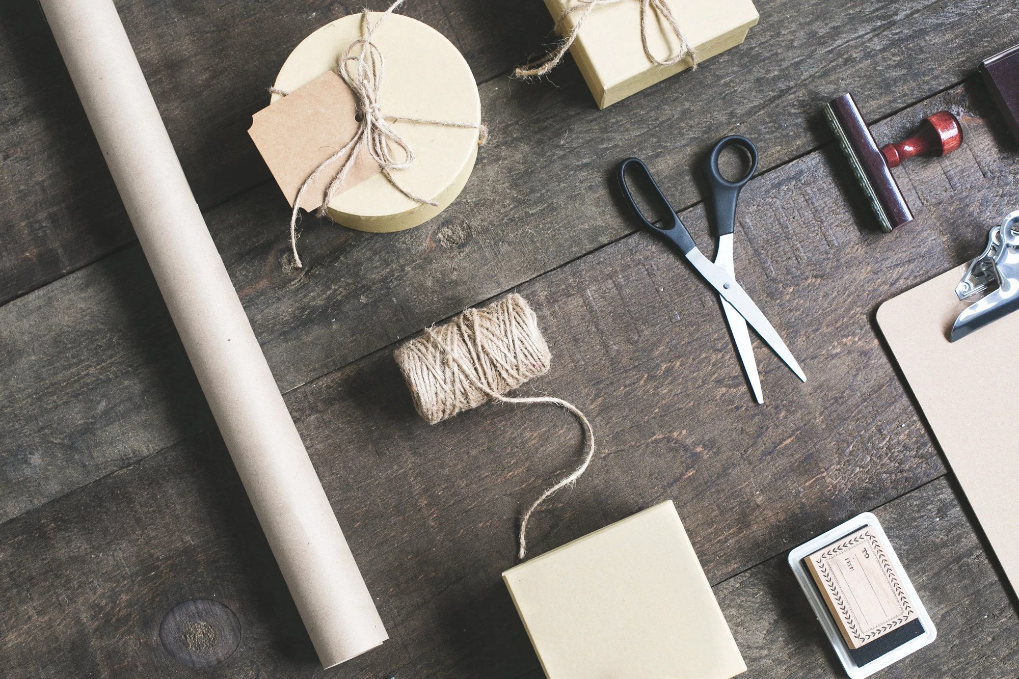 Flatlay of shipping supplies on a wooden surface