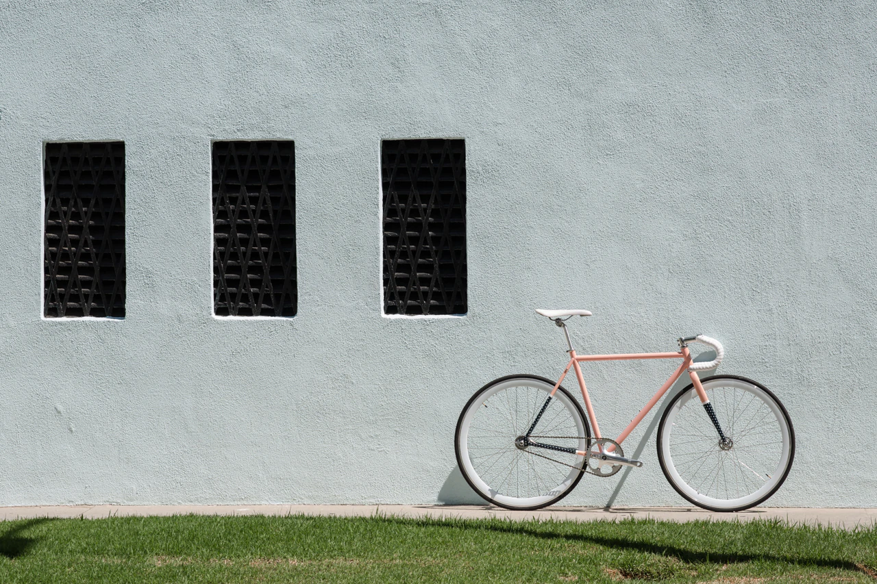 A bike from State Bicycle Co. against a white wall.