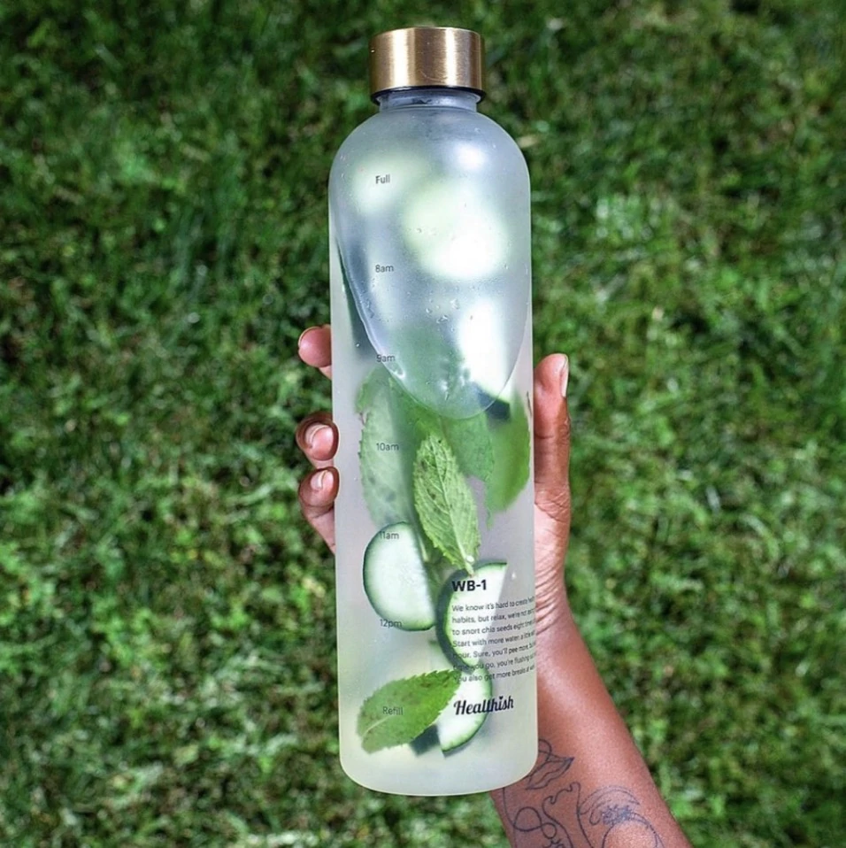 A Healthish water bottle filled with cucumbers and mint along with water.