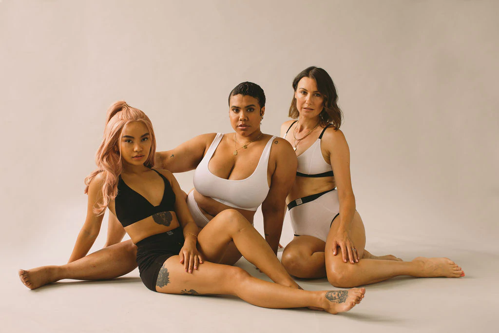 Three models wearing Pantee collections sitting on the floor